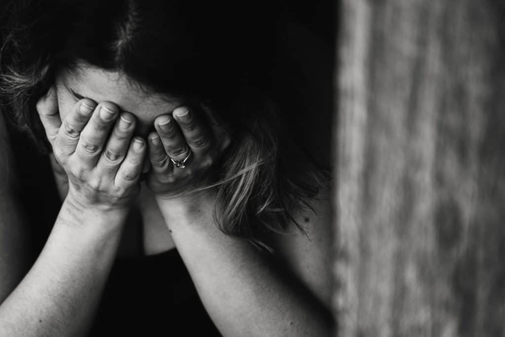 A woman with her head in her hands